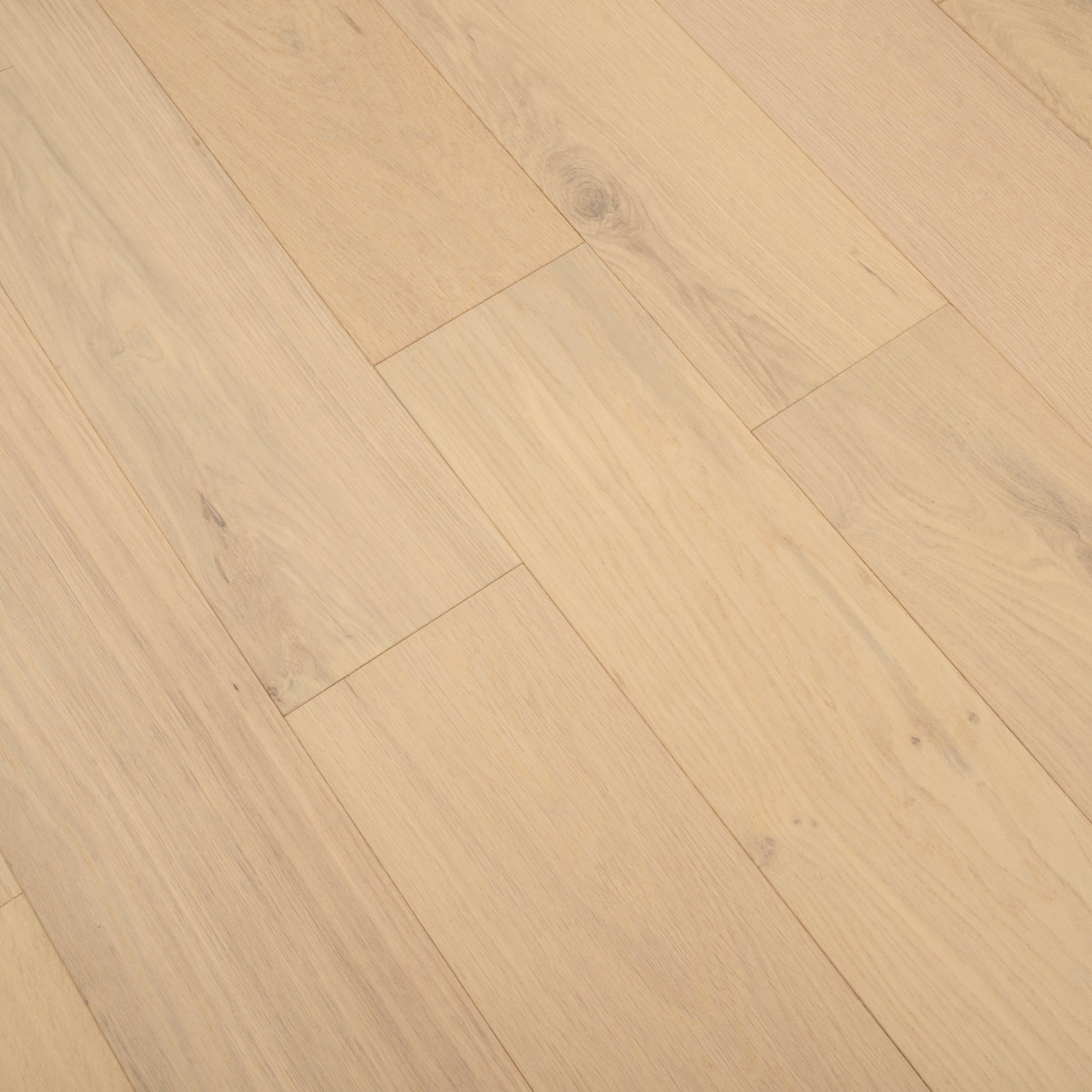 Close-up of a wooden floor with a light brown color and visible grain pattern.