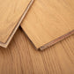 Close-up of wooden flooring panels with a focus on texture and grain.