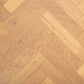 Brushed wooden floor with herringbone pattern