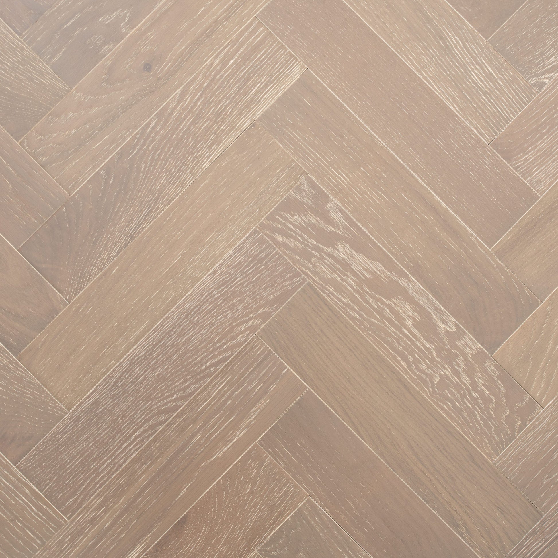 Close-up of a wooden floor with a herringbone pattern