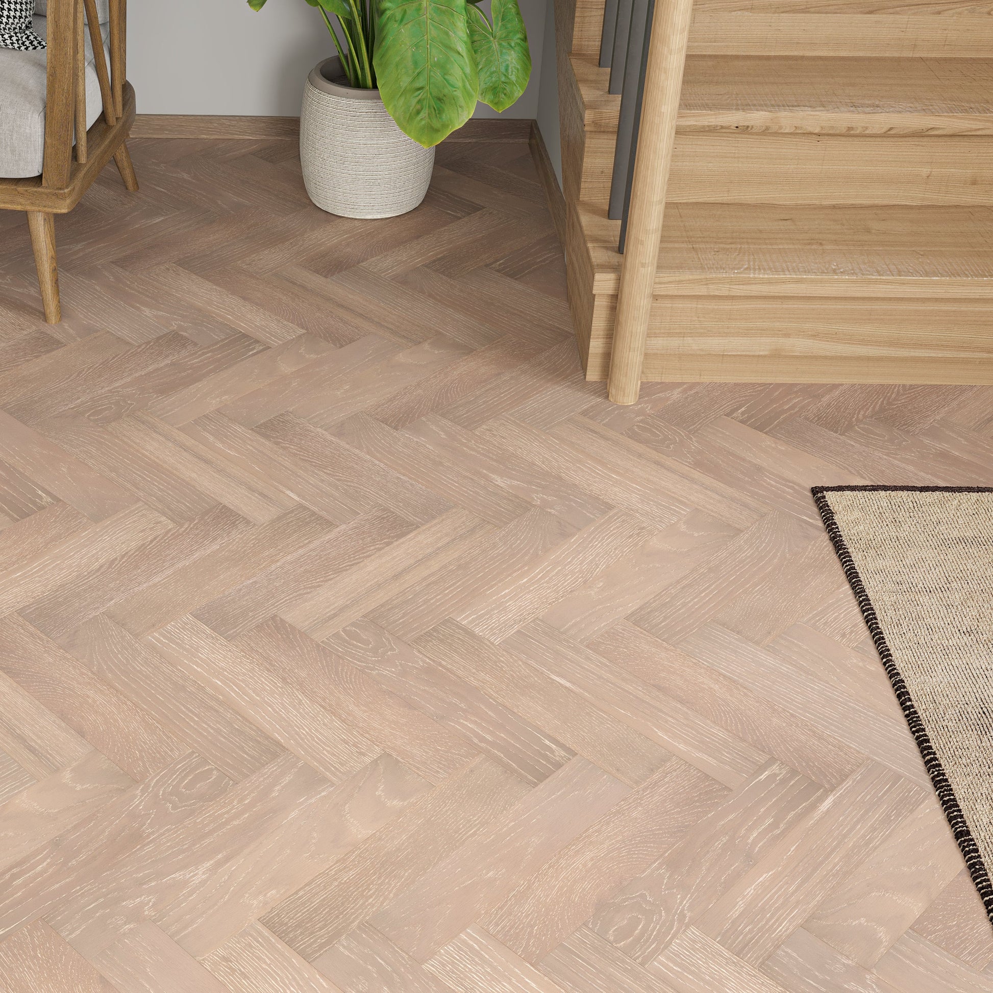 Wooden flooring with a herringbone pattern in a room setting.